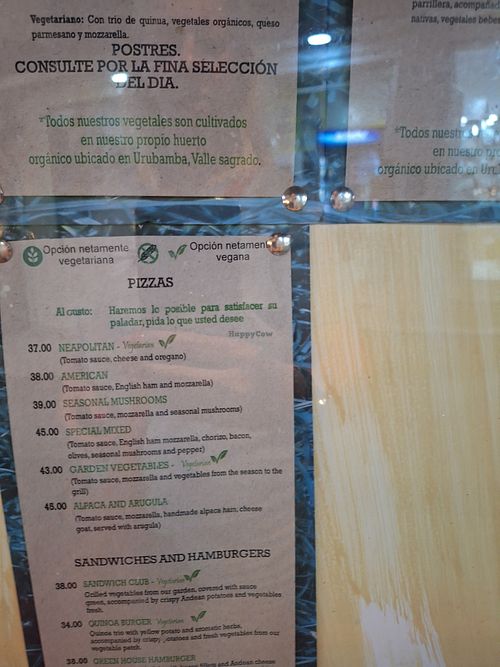 Recent menus and a photo of the entrance. at Green House in Aguas Calientes