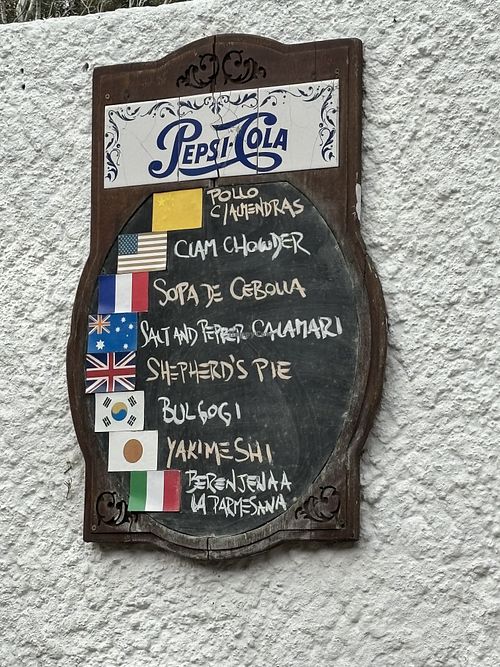 Multiple signs like this with different countries   at Pasaje De Las Flores in Colonia Del Sacramento