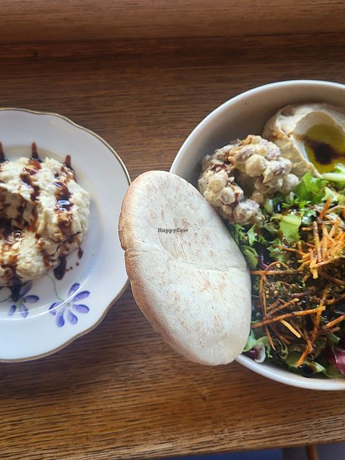 Dish with hummus, beans, salad, bana ganoush and pita at Hummusson in Malmo