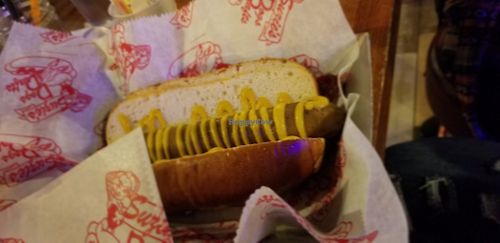 Vegan dog with pretzel bun and mustard at Suzie's Dogs in Boardman