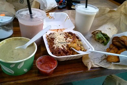 Chili cheese fries, wrap, green curry, yam discs, strawberry and vanilla shakes at Evolution Fast Food in San Diego