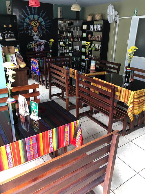 Seating area with organic coffee, guayusa, cacao, beer, panela, body care products and more for sale at Semillas in Zamora