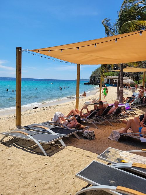 Lounge chairs on the beach... Many people at Kokomo Beach Restaurant in Willemstad