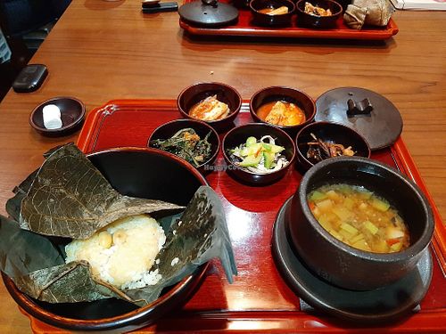 4th, main: rice in lotus leaf and fermented bean soup. the side dishes including kimchi are vegan at Balwoo Gongyang - 발우공양 in Seoul