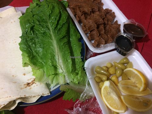 kofte (vegan meatballs from bulgur), enjoyed with lavash flatbread, pomegranate sauce, spicy pepper sauce, lemon and peppers. at CMR Cig Kofte in Kyrenia