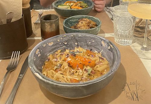 Pumpkin pasta and curry noodles (special) in the background.  at Winners Vegan Restaurant in Athens