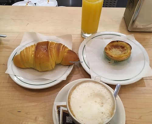 Vegan croissant and pastel de nata, orange juice, cappuccino with soy milk at Pastelaria Tupi in Porto
