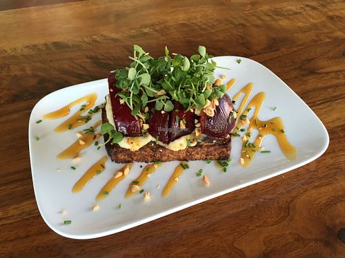 Seared stone fruit bruschetta with herbed macadamia cheese, golden balsamic reduction, hazelnuts, micro basil. at Encuentro in Oakland