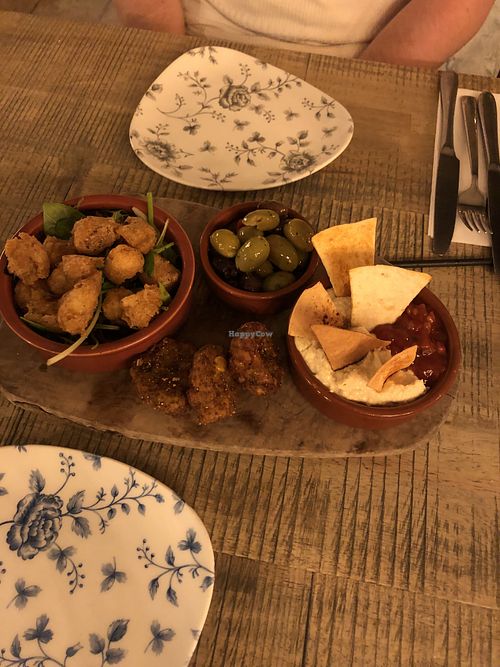 The starter was the highlight - vegan platter including popcorn cauliflower, olives, sweet corn fritters, hummus and relish!  at The Huntsman Inn in Holmfirth