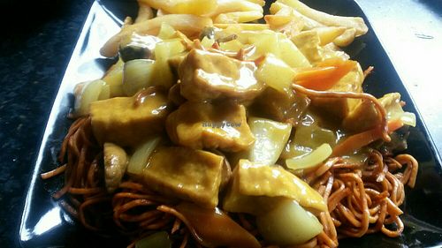 Tofu curry with vegan noodles and chips at Yummy Cottage in Newcastle Upon Tyne