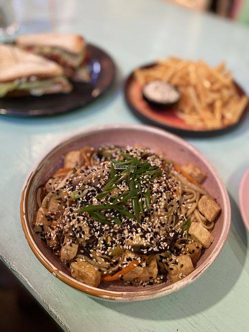 Fried noodle with tofu, vegan tempeh sandwich, fries at Vegan Beats in St Petersburg
