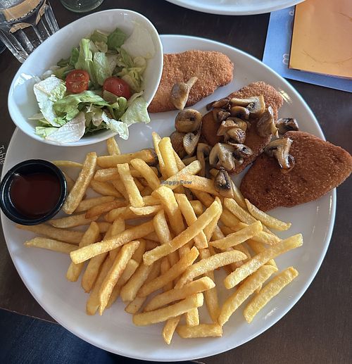 Vegan Schnitzel with fries, a side of baked mushrooms and ketchup  at Cafe Del Sol in Hamm