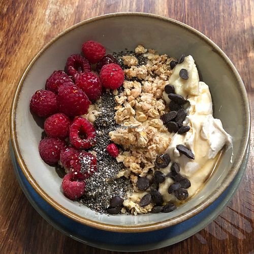 Overnight oats (were actually warm like porridge) with granola, nut butters, yogurt, chia seeds and raspberries  at Mother Nature in Cardiff
