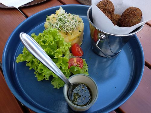 Vegan deep fried, crispy pea-balls with a garden herb dip and homemade potato salad. at Gasthaus Siriuskogl in Bad Ischl
