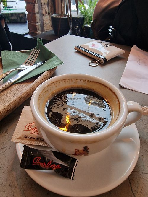 Coffee comes with chocolate covered coffee bean at Kozy Eats  in Riga