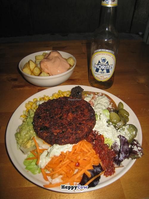 Meal Deal - burger of choice with salad, patatas bravas and alcohol-free beer at Gopal - Vegan Deli in Barcelona