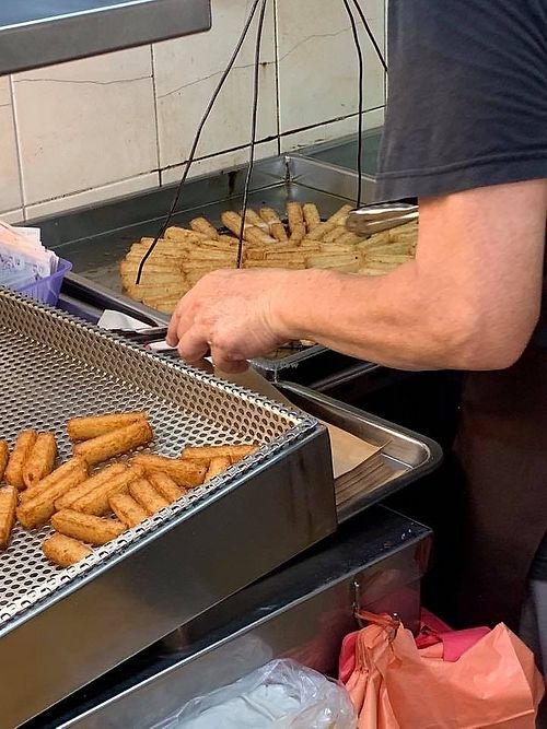 Into the boiling oil. 
Photo by Mr Henry Lau at Deep Fried Carrot Cake 现炸萝卜糕 in Central Singapore