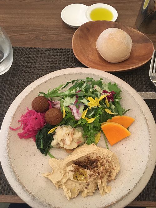 Hummus with salad and 3 deli items.  at PEACE TABLE - 渋谷 道玄坂店 in Tokyo