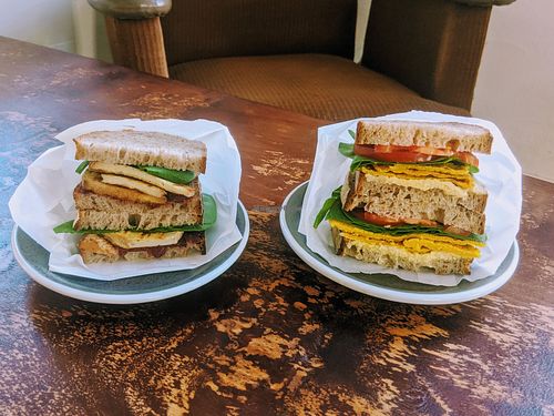Smoked tofu and cranberry sandwich. Chickpea omelette, hummus and tahini sandwich. at Bez Chabasu in Poznan