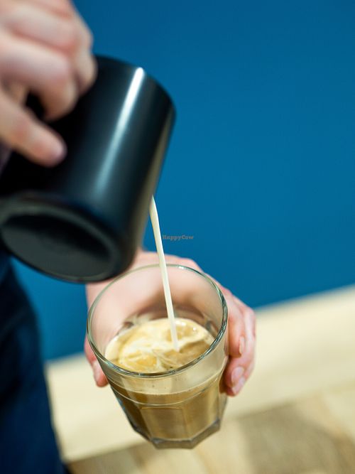 Making a flat white. Oatly Milk and specialty coffee. at NEØ Coffee House in Barcelona
