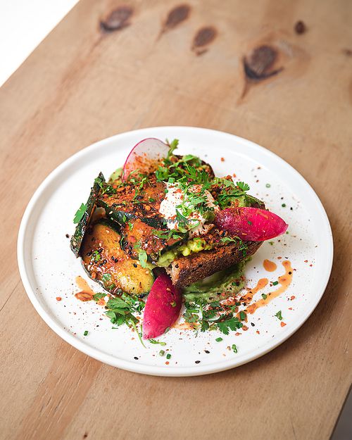 Avocado toast with kimchi cuncumber, radish at NEØ Coffee House in Barcelona