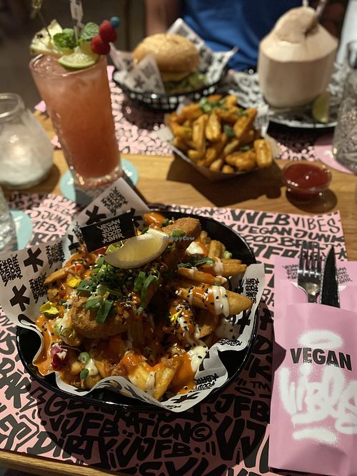 Vegan Cod, XL Cajun fries, Mc Cruelty Free burger, Holy Dragon and Vatos Cocos cocktail  at Vegan Junk Food Bar - El Born in Barcelona
