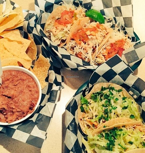 Vegan fish and Vegan Chicken tacos with chips and a side of refried beans at Pelon's Baja Grill in Norfolk
