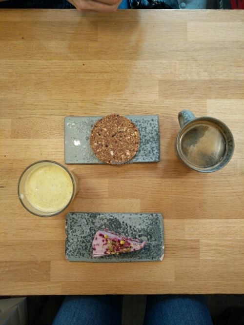 the rasberry coconut cake, pineapple apple mint juice, coffee and the chocolate chip cookie at 42°Raw in Copenhagen