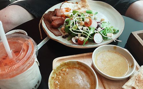 All american breakfast, fresh carrot, apple and ginger juice and left overs from pork satay. at VIBE Coffee & Plant-Based Food in Bangkok