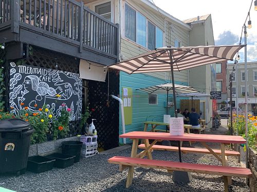 Outdoor seating on the side of the building at The Mermaid Cafe in Catskill