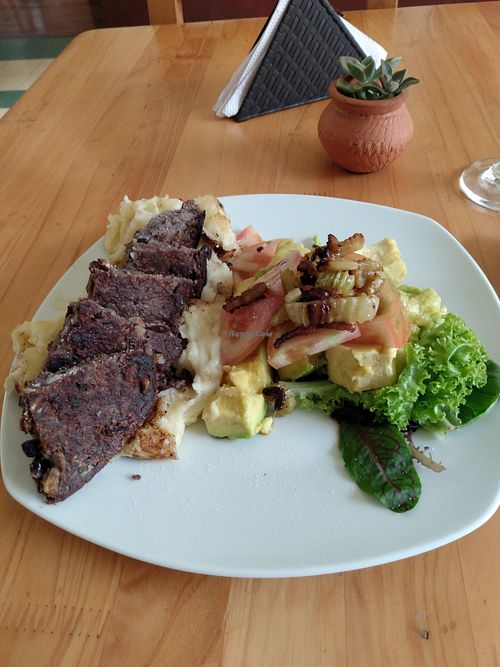 Lunch of the day: black bean patty on mashed potatoes. Salad with lettuce, avocado and tomato at El Arrebato in Medellin