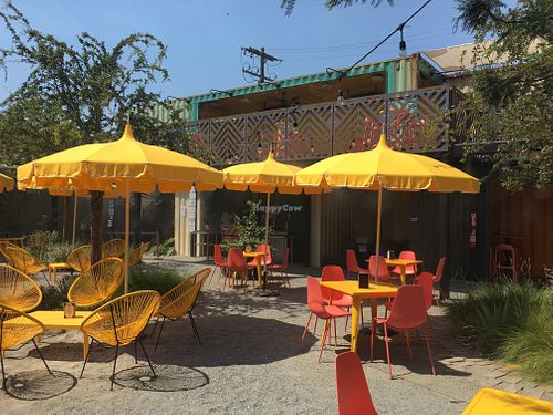 Outside seating and two-level shipping container seating at Modern Times Leisure Town in Anaheim