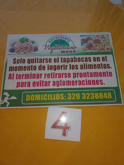 Sign on table at Restaurante Vegetariano Maná - La Pamba in Popayan
