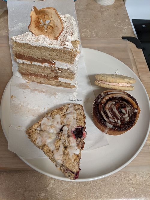 my chosen treats today (January 2021) - cake, sandwich cookie, cinnamon roll, jam scone at Flourchild Vegan Baking  in Courtenay