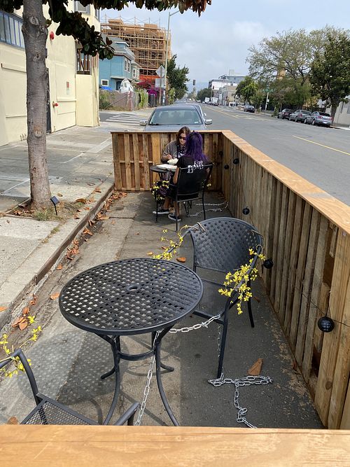 Small outdoor seating area at Hella Nuts in Oakland