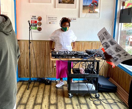 DJ spinning for the outdoor tables to celebrate Trinidad and Tobago’s Independence. at Coco Breeze in Oakland