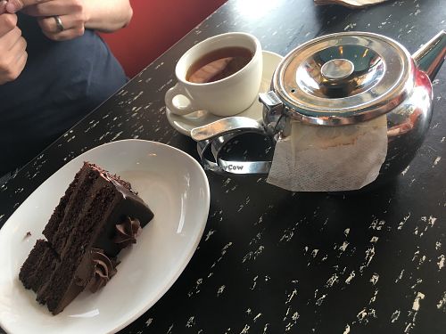 vegan chocolate cake and pot of chai tea at Flying Star Cafe in Albuquerque