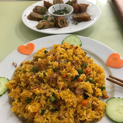fried rice and Lemon chicken ---- Ching Hai videos playing in the background --- pure heaven  at Loving Hut - Âu Cơ in Hanoi