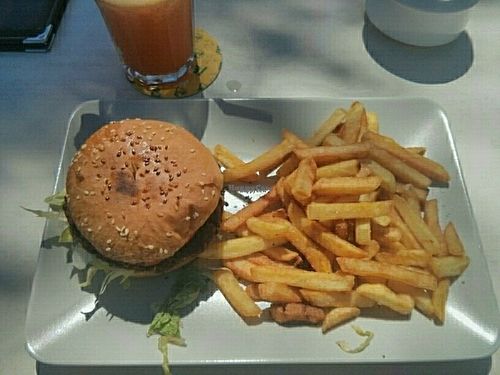 Veggie burger (vegan when ordered without cheese), fries, and fresh juice. at Surf Corner Veggie Tapas Cafe in Lanzarote