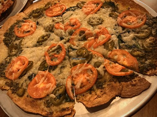 12" (one size) build-your-own pizza with vegan cheese, cracker crust, basil pesto sauce, tomatoes, garlic and jalapeños  at Peddlers Pizza Pub in Valparaiso