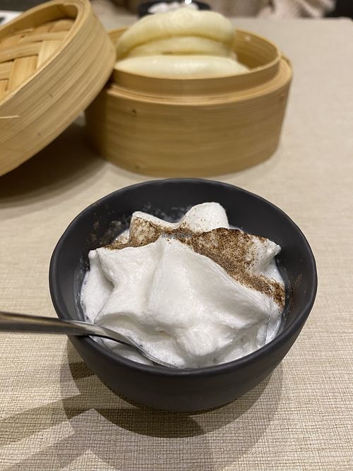Chinese steamed bun in a bamboo basket with whipped coconut x cauliflower cream  at La Cafetière Fêlée in Antibes