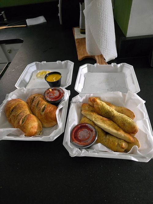 One order each of breadsticks (cheese sticks with no cheese) and custom pepperoni rolls (tofu, vegan cheese, no pepperoni) at The Woods in Huntington