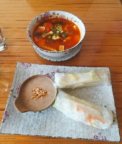 Sour hot	soup & summer rolls (served with peanut and coconut sauce) at Well Being in Cologne