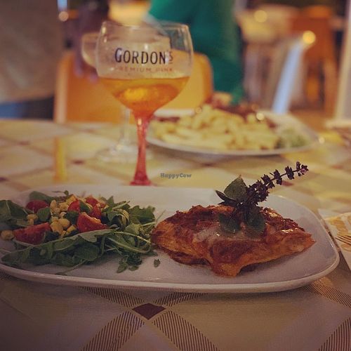 Cheese-free Lasagna with salad greens at Historic Route 66 Pub in Caltanissetta