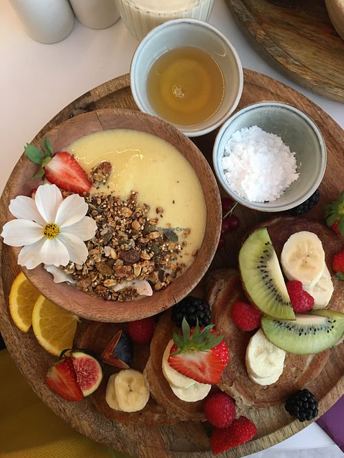 The vegan breakfast with golden smoothie bowl, banana pancakes and fresh fruit. at Sofia in Oostende