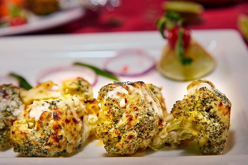 Broccoli florets dressed in cashew nut cream at AWADH in Central Singapore