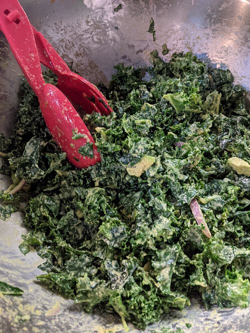 Kale salad with red onion, avocado, housemade dressing at RA Vegan Cafe in Houston