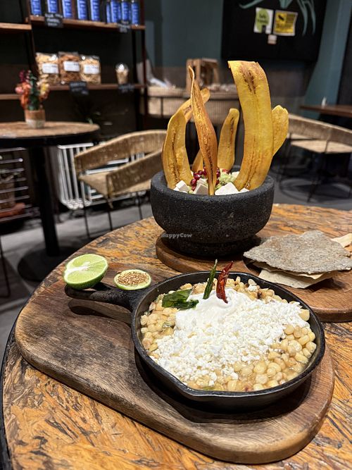 Guacamole with plantain chips, corn and vegan cheese dip  at Ojo de Maíz in Mexico City