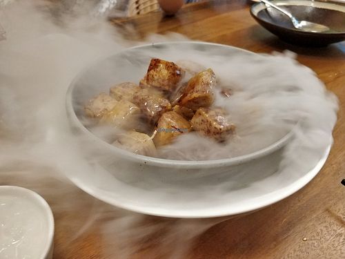 Caramelised Yam Dices with Raw Sugar. Smoke by the sides are from dry ice. at Lotus Vegetarian 莲心 - Novena in Central Singapore