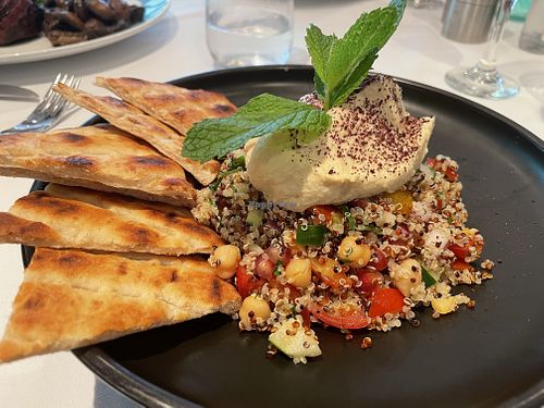 Pomegranate, quinoa, and taboulleh salad served with hummus and flatbread at Oolaa - Stanley St in Hong Kong Island